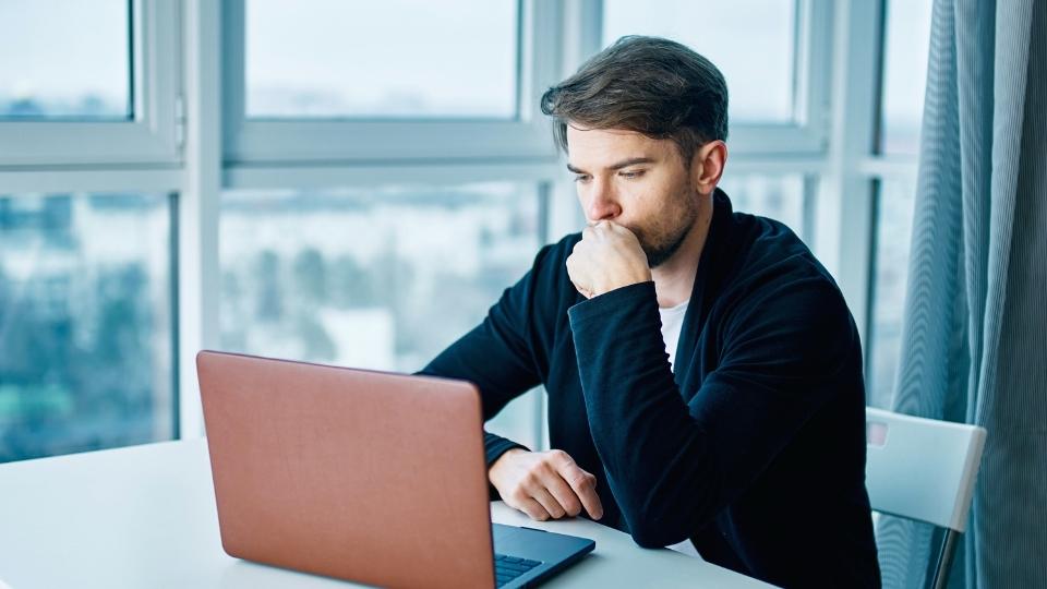 How Long Does Liquor Stay in Your System a man looks up the answer on his laptop.