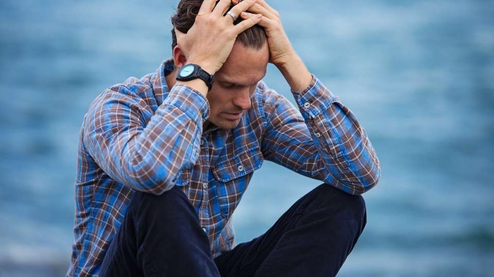 Is Lorazepam Addictive? hero image of a man holding his head while facing psychological addiction