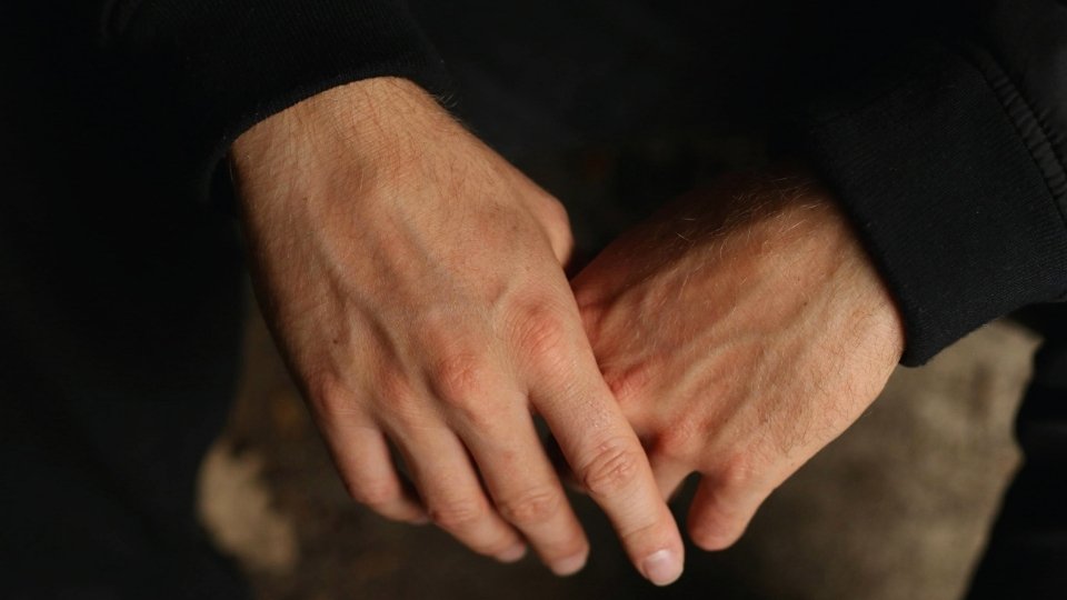 Shakes from Alcohol hero image of a man's hand.