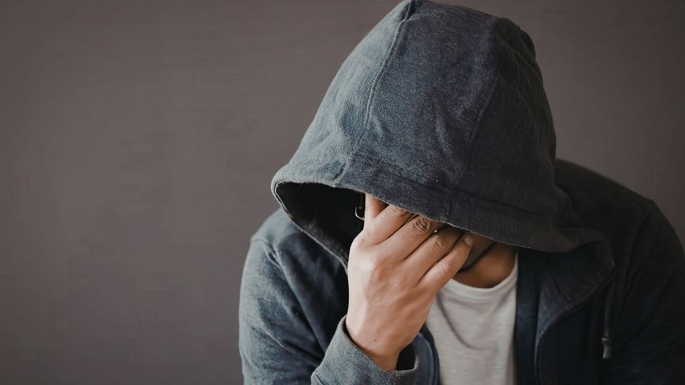 meth tweaking hero image of man covering face in hood